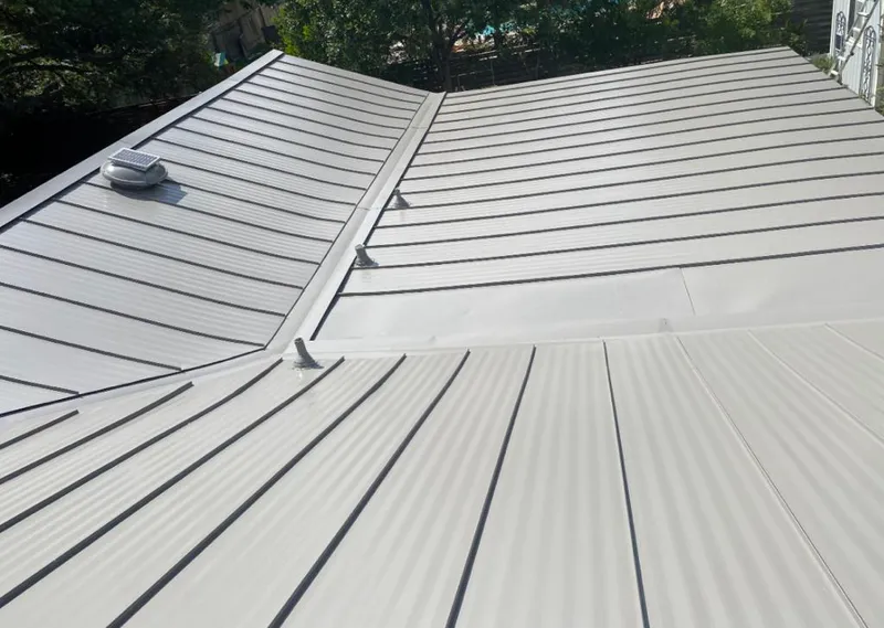 Solar attic fan installed on a metal roof for Roof Ventilation in Seven Corners